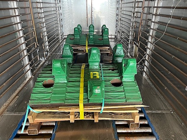 Green platen castings strapped on pallets inside a DCI chamber
